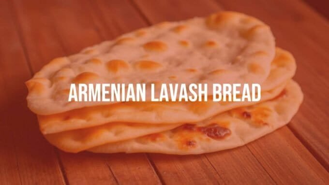Traditional Armenian lavash bread, freshly baked, thin and soft, on a wooden table with rustic background, warm golden tones, realistic.
