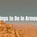 A panoramic view of ancient Armenian monastery on a cliff, surrounded by majestic mountains and clear blue skies, vibrant colors, realistic.