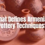Traditional Armenian pottery pieces with intricate patterns, warm earthy colors, and cultural symbols, arranged on a rustic wooden table, natural daylight, detailed and realistic.