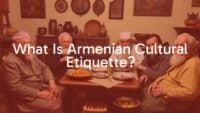 Traditional Armenian family gathering, warm hospitality, elders seated at table, sharing food, cultural artifacts in background, cozy and respectful atmosphere, realistic.